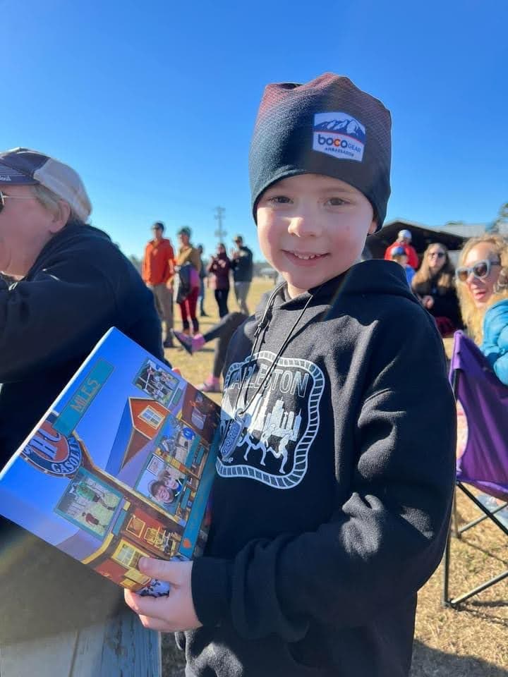 Young kid holding a Farm Daze race booklet